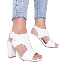 Sandálias brancas em uma postagem Candy Style branco