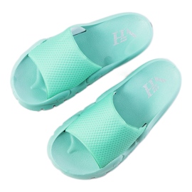 Chinelos distantes verdes de mulher