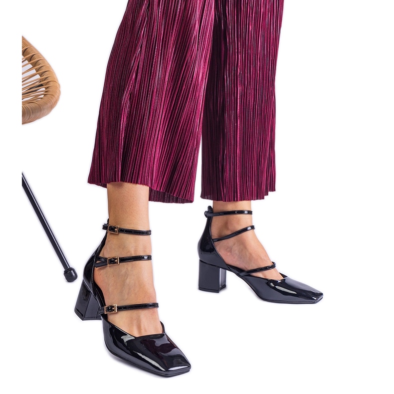 Bombas pretas envernizadas em um post com fivelas preto Bombas pretas envernizadas em um post com fivelas preto