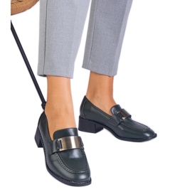 Sapatos verdes em um post baixo com uma decoração metálica