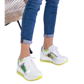 Tênis esportivos femininos brancos com um acessório colorido