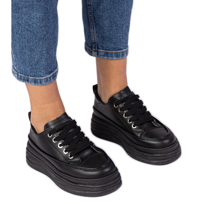 Tênis de mulheres negras em uma sola alta preto