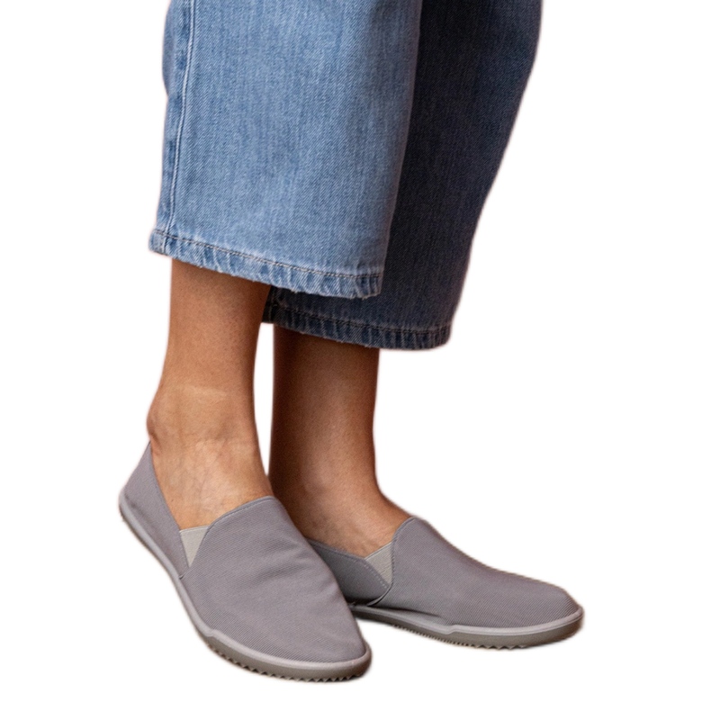 Tênis cinzentos de mulheres cinza