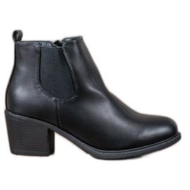 Anesia Paris Botas pretas em um poste preto Anesia Paris Botas pretas em um poste preto