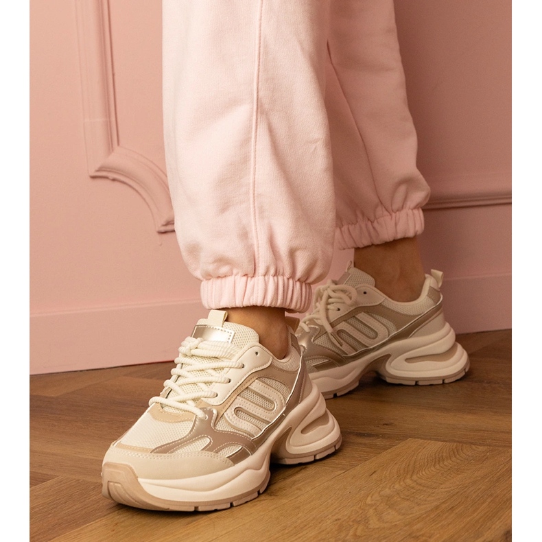 Tênis esportivos bege em uma sola enorme 1