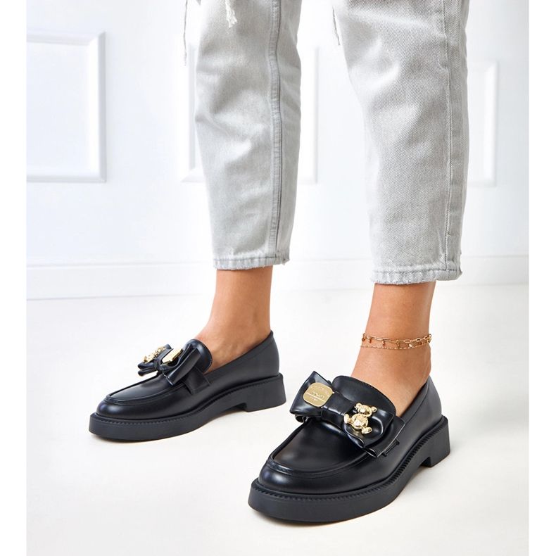 Mocas pretos com um arco e ursinho de pelúcia 1