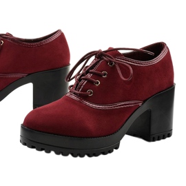 Botas marrons amarradas em um bloco Clearfall vermelho 1