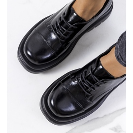 Sapatos pretos em uma sola de trator de Henta 1